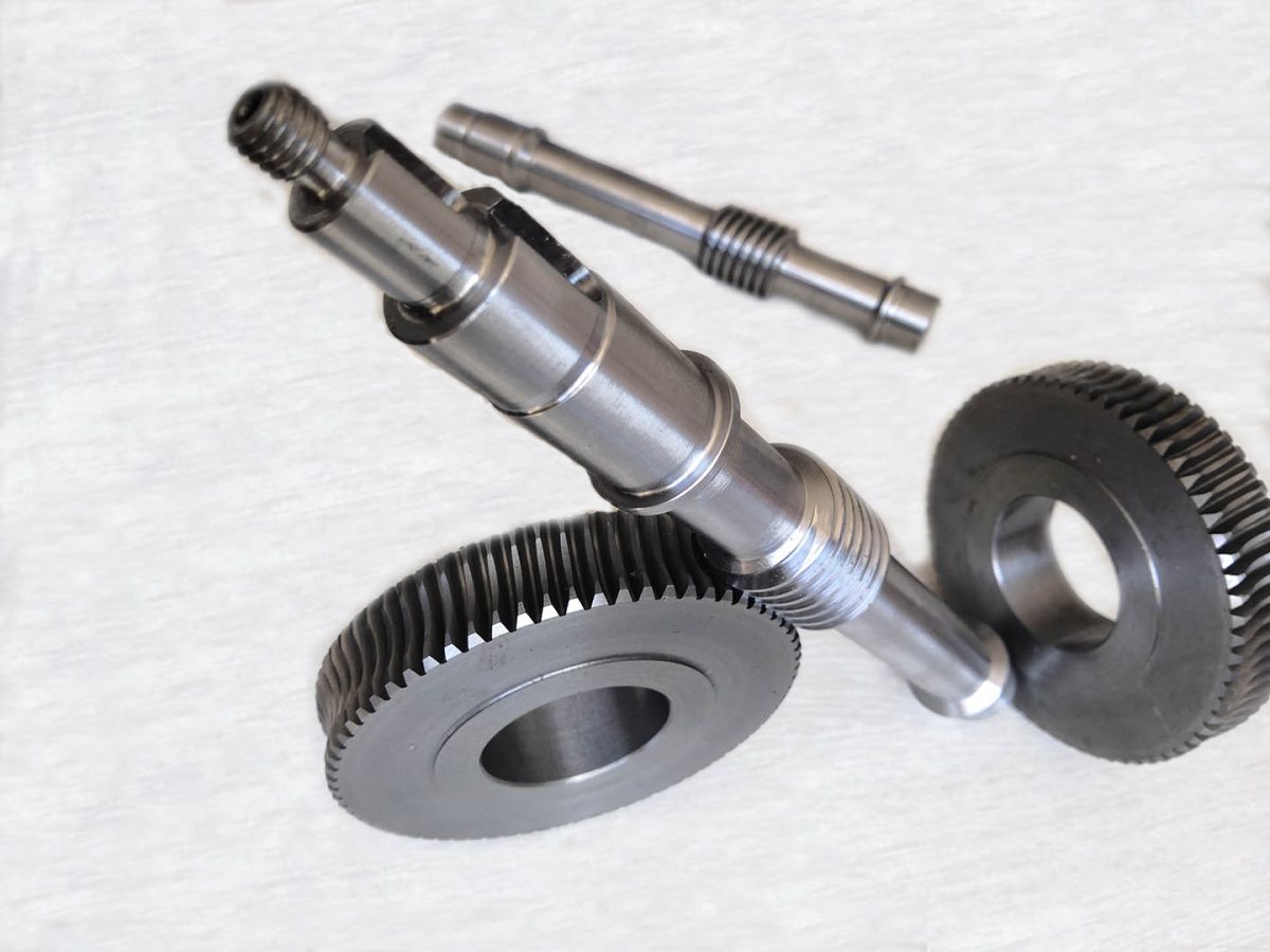 The worm gear and shaft sit at the center