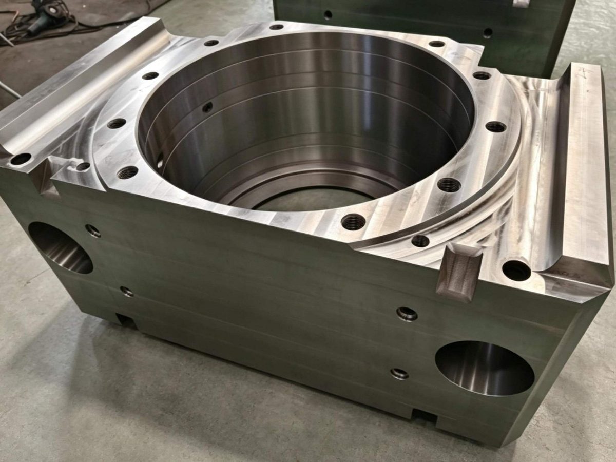 A precision-machined housing with a large circular bore, mounting holes, and clean milled surfaces